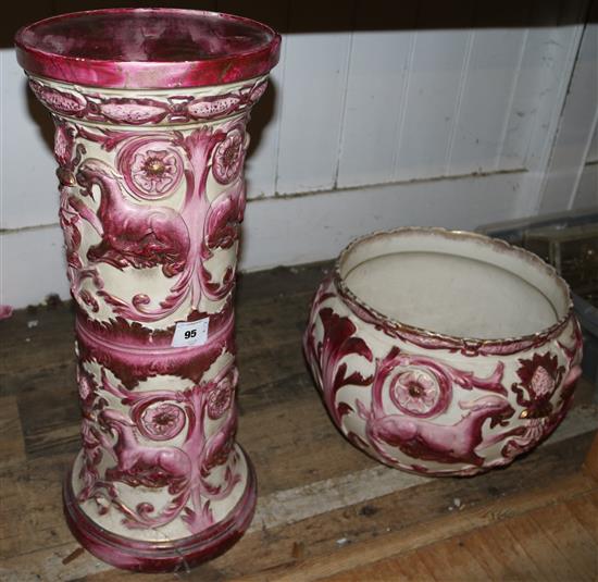 A Royal Doulton pink and red jardiniere on stand, decorated with griffins